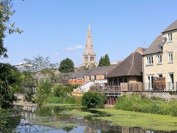 View of building by river against sky