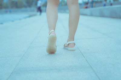 A girl is walking on her feet