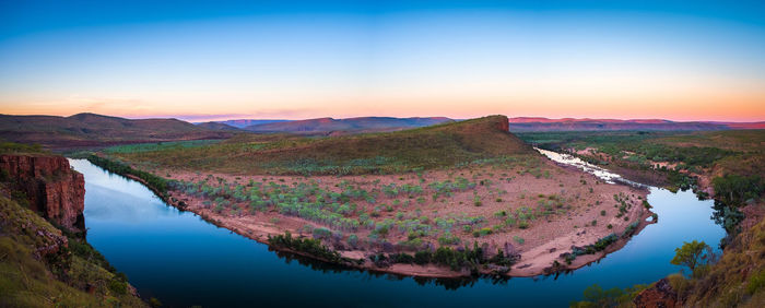 Scenic view of lake against sky at sunset