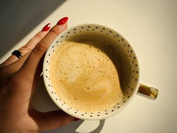 Close-up of hand holding coffee cup