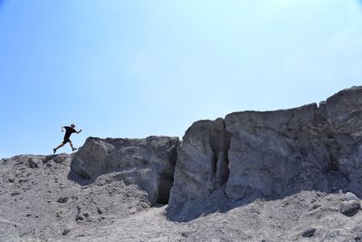 Low angle view of rock formations against sky