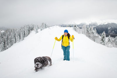 Dog on snowcapped mountains during winter