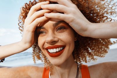 Portrait of young woman with curly hair