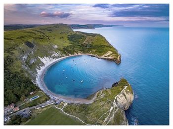 Aerial view of sea against cloudy sky