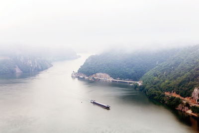 High angle view of river amidst trees against sky