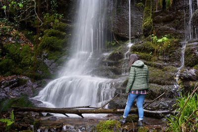 Woman traveler on a waterfall in gondramaz, portugal