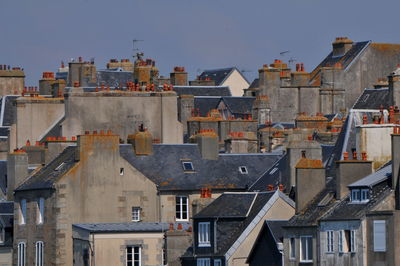 Buildings in city against clear sky