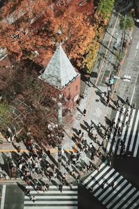 High angle view of people walking on road by buildings