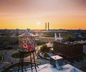 High angle view of buildings in city during sunset