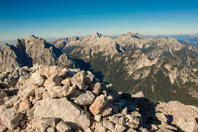 Rocks on mountain against blue sky