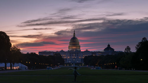 Buildings against cloudy sky at sunset