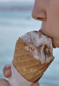 Midsection of person eating ice cream