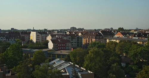 Buildings in city against clear sky