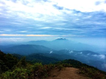 Scenic view of mountains against cloudy sky