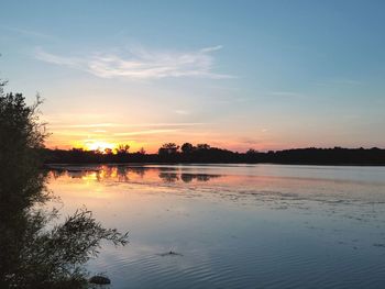 Scenic view of calm lake at sunset