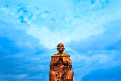 Low angle view of statue against blue sky