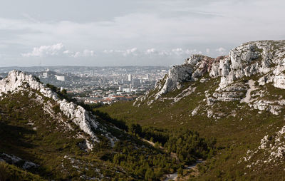 Scenic view of hill against cloudy sky