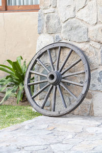 Bicycle by wall against building