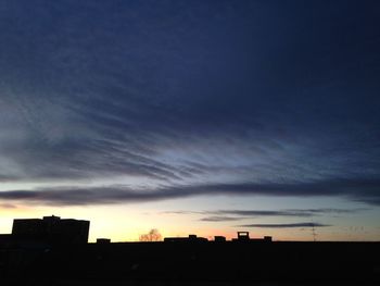 Low angle view of buildings against cloudy sky
