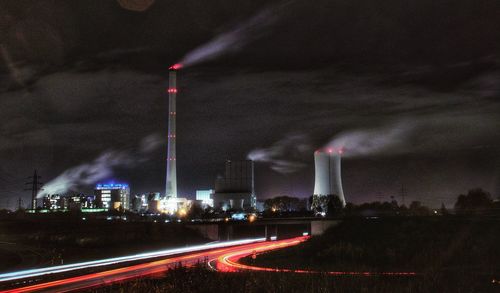 Smoke emitting from factory against sky at night