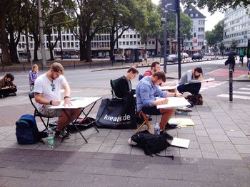 People sitting on footpath