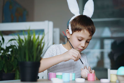 Portrait of young woman painting