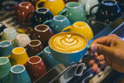 Cup of latte art coffee on wood background vintage tone, shot from above shallow depth of field