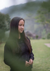 Full length of smiling woman standing on land