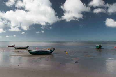 Boats in sea against sky