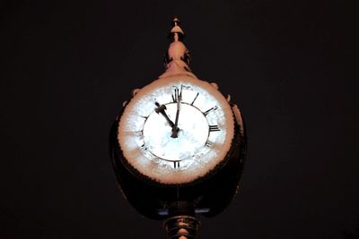 Close-up of clock against black background