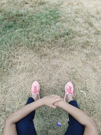 Low section of woman standing on field