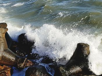 High angle view of waves splashing on sea