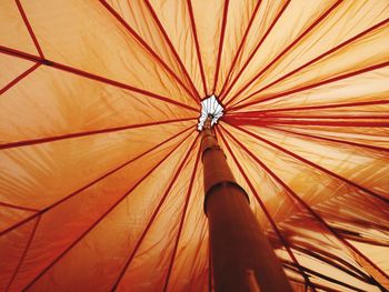 Low angle view of orange parasol