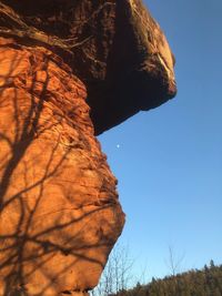 Low angle view of rock formation against clear sky