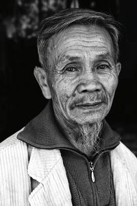 Close-up portrait of senior man sitting outdoors