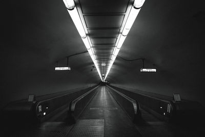 Moving walkway in illuminated tunnel