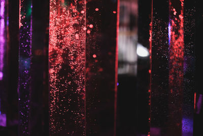 Close-up of wet glass window at night