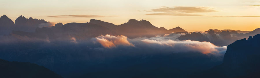 Panoramic view of silhouette mountains against sky during sunset