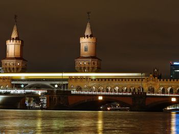 View of illuminated tower bridge and buildings at night