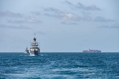 Ship sailing in sea against sky