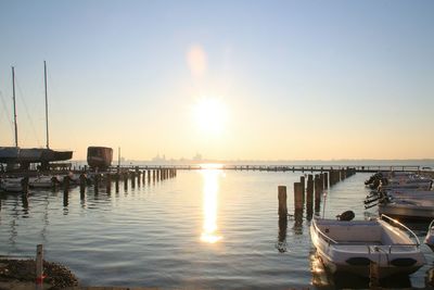 View of boats in calm lake at sunset