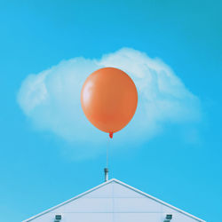 Low angle view of balloons against blue sky