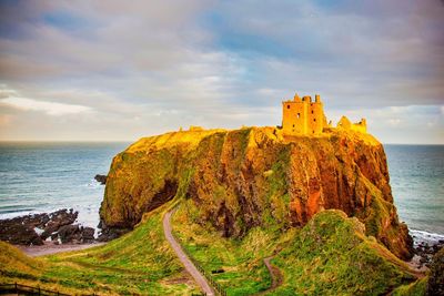 Scenic view of sea by building against sky