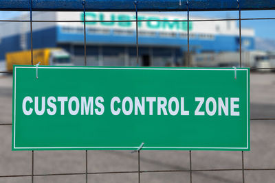 Close-up of information sign on glass