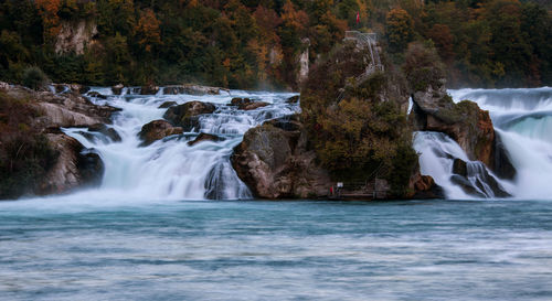 Long exposure photograph of the rhein falls with the laufen castle on the background.