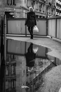 Rear view of man at puddle