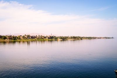 Scenic view of lake by building against sky