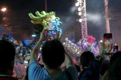 People photographing at music concert