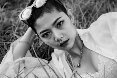 Close-up portrait of young woman lying outdoors