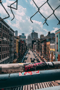 City street and buildings against sky